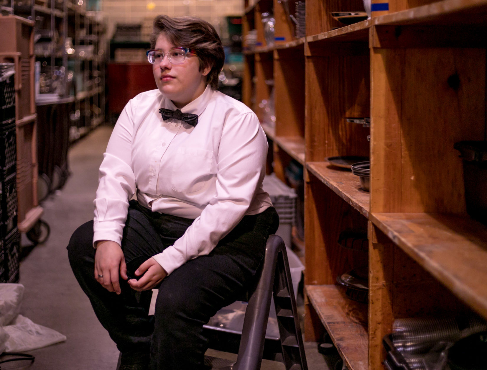 Kasper Ramirez stands in the storage space of Stephens College dining services